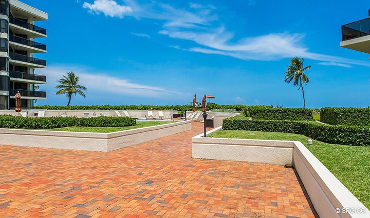 View of the Pool Area from Residence 1-102 For Sale at Oasis, Luxury Oceanfront Condos in Palm Beach, Florida 33480.